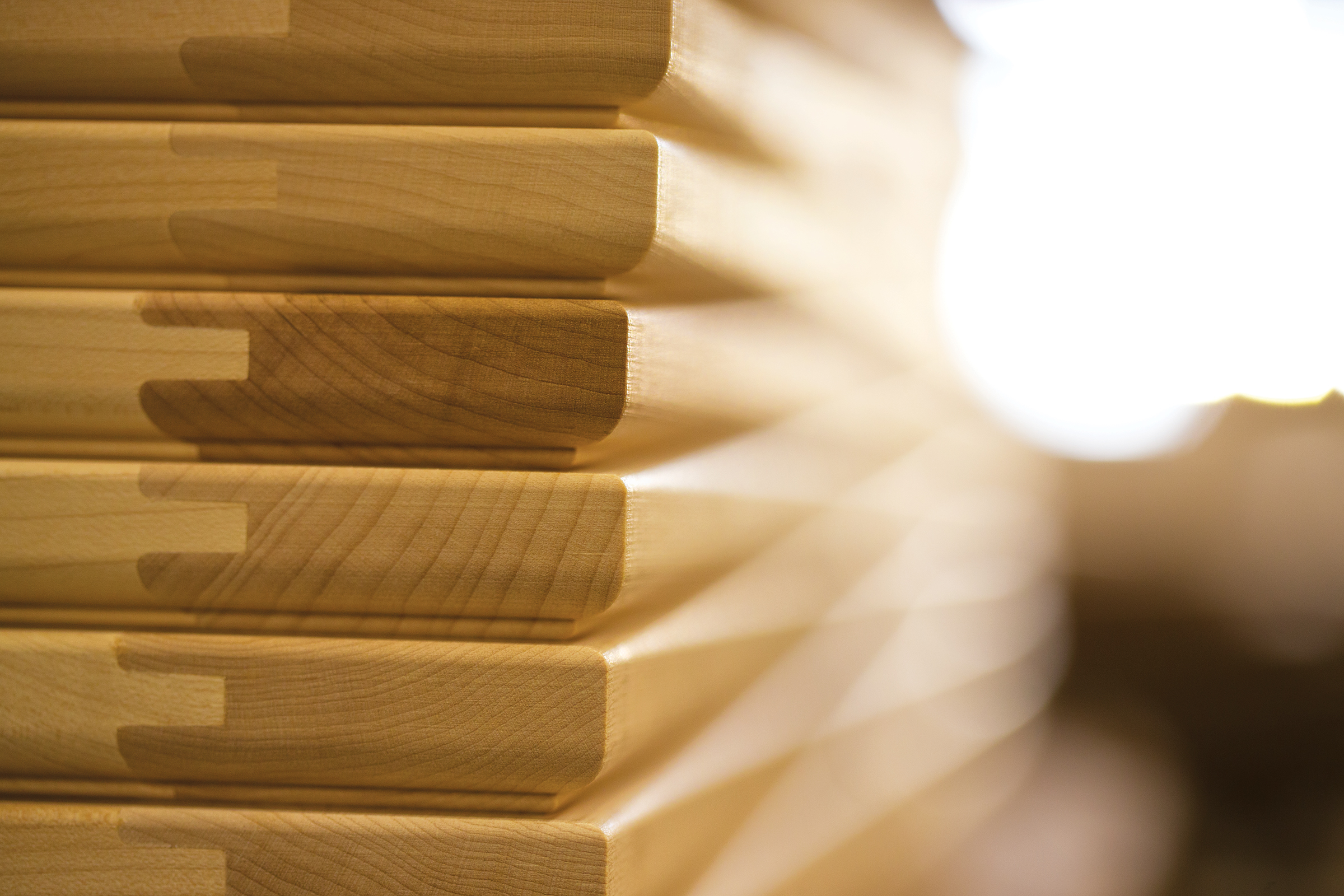 Close-up view of stack of kitchen cabinet doors awaiting finish and assembly at KraftMaid factory