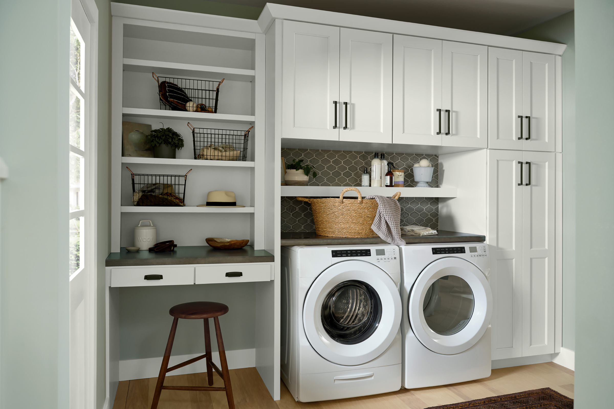 KraftMaid White washer dryer cabinets with corner workspace nook